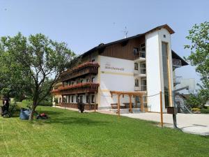 a building with a lawn in front of it at Hotel Märchenwald in Haidmühle