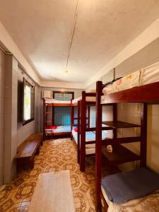 a room with three bunk beds in a house at Maracujá Hostel in Paraty +26 photos