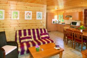 a living room with a couch and a table at Les Rochettes Pluton 4 in La-Roche-en-Ardenne