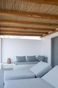 a living room with a couch and a wooden ceiling at Oskelos in Kastraki Naxou +102 photos