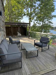 a deck with chairs and a couch and a swing at Haven Fortress in Kalven