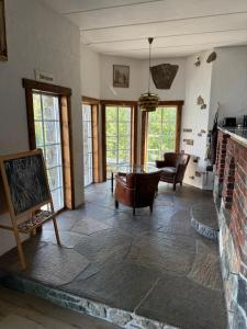 a living room with a brick fireplace and a table at Haven Fortress in Kalven