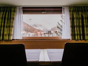 a table in front of a window with a view at Apartment Bergsonne in Samnaun