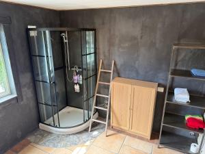 a shower in a room with a ladder and a shelf at Haven Fortress in Kalven +13 photos
