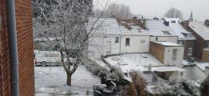 a view of a snow covered city with houses at CHAMBRE Privée in Seraing
