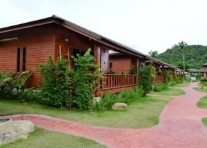 a log cabin with a walkway in front of it at PingChan Koh Phangan Beachfront Resort in Thong Nai Pan Yai