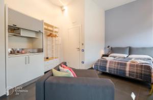 a living room with a bed and a couch at B&B Un Passo Dal Treno Piazza Vittorio Veneto 36-Salerno Station-Building under renovation in Salerno