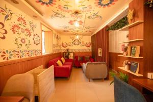 a waiting room with red couches and flowers on the ceiling at Mayu Boutique Hotel in Cusco