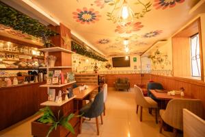 a restaurant with tables and chairs and flowers on the ceiling at Mayu Boutique Hotel in Cusco