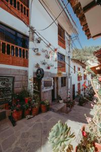 a building with potted plants in front of it at Mayu Boutique Hotel in Cusco