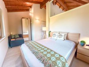 a bedroom with a large bed and a chair at un MONDO A PARTE in Monsampolo del Tronto