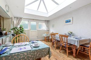 a kitchen and dining room with a table and chairs at Capritia Guest House in Dartmouth