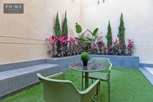 a patio with a table and chairs and plants at Prime Residence Zayed Heights in Sheikh Zayed +166 photos