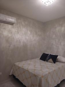 a bedroom with a bed with a pillow on it at Calmaria in Matinhos