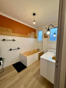 a large bathroom with a tub and a sink at Un Mendi in Argelès-Gazost