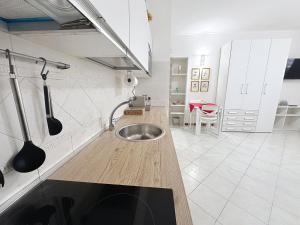 een keuken met een roestvrijstalen spoelbak in het aanrecht bij Alloggio Turistico - I tre Moschettieri - Zona Universitaria e Tribunale Nuovo in Viterbo +19 foto's