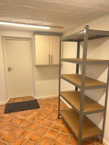 a room with a book shelf and a door at Cozy Corner in Augustenborg