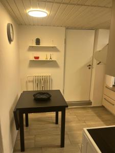 a dining room with a table and a door to a kitchen at Cozy Corner in Augustenborg +7 photos