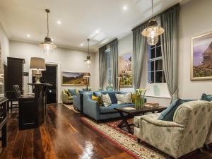 a living room with a blue couch and chairs at Mantis St Helena in Jamestown
