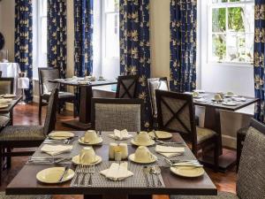 a dining room with a table with plates and utensils at Mantis St Helena in Jamestown