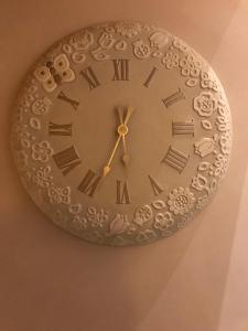 a clock is hanging on a wall at Chalet Taulei tra Bormio e Livigno in Valdidentro +33 photos