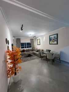 a living room with a couch and a table at Relaxing Apartment Near the Beach Malabata Tanger in Tangier