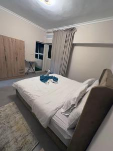 a large white bed in a bedroom with a window at Relaxing Apartment Near the Beach Malabata Tanger in Tangier +11 photos