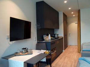 a kitchen with a table and a counter top at Lakeside Central Apartment Wörthersee - Free covered Parking, Train & Bus & Supermarket with Supercharger in Sekull