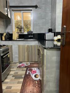 a kitchen with a counter with two plates on it at Tiny Card Milimani Homes in Kisumu