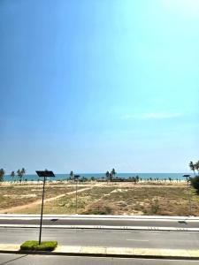 a road with a view of the beach and the ocean at CHROME Résidences Fidjrossè PLAGE in Cotonou