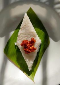 a piece of food sitting on top of a green leaf at Wilpattu Nuga Lodge in Pahala Maragahawewa