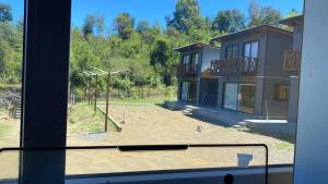 una finestra con vista su un parco giochi di Cabañas alto de coñaripe a Coñaripe