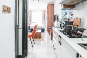 a kitchen with white counters and a stove top oven at Kilimani Chic Studio in Nairobi