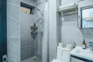 a bathroom with a shower and a toilet and a sink at Kilimani Chic Studio in Nairobi +5 photos
