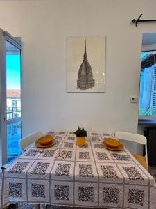 a dining room table with a patterned table cloth on it at Fandara Suites in Turin