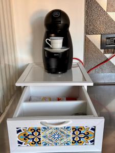 a coffee maker sitting on a shelf in a refrigerator at Fandara Suites in Turin