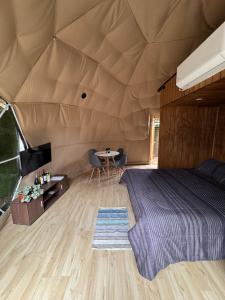 una camera da letto in una tenda con un letto e un tavolo di Domo con Tinaja Privada a Tomé Altre 3 foto