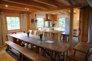een keuken en eetkamer met een houten tafel bij La Grande Ourse in Durbuy