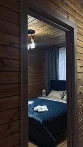 a bedroom with a bed in a wooden wall at Torino Resort & Spa in Dragonya
