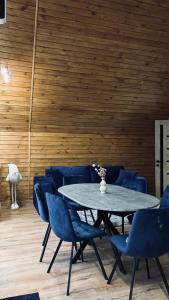 a dining room with a table and blue chairs at Torino Resort & Spa in Dragonya