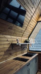 a kitchen with a stove and a wooden ceiling at Torino Resort & Spa in Dragonya
