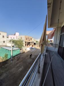 a dog standing on the balcony of a building at Kripanidhi Homestay in Jodhpur +1 photo