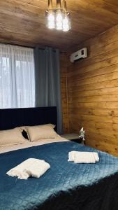 a bedroom with a bed with two towels on it at Torino Resort & Spa in Dragonya +6 photos