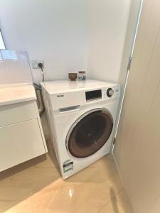 a washer and dryer in a small room at Parkside in Bethlehem in Tauranga