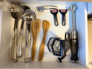 a bunch of utensils are arranged in a drawer at Balkan Hostel in Tirana
