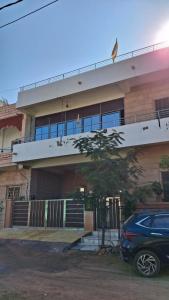 a building with a car parked in front of it at Kripanidhi Homestay in Jodhpur