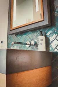 een badkamermeubel met een wastafel en een spiegel bij Harz BnB Werkmeister in Sankt Andreasberg