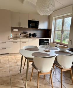a kitchen with a table and chairs in a kitchen at Cozy Beach Home in De Haan