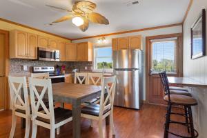 een keuken met een houten tafel en een roestvrijstalen koelkast bij 6153 - Seascape in Nags Head