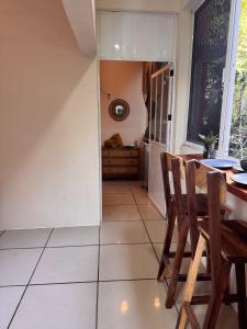a dining room with a table and chairs and a window at Casa Nawara in Puerto Escondido